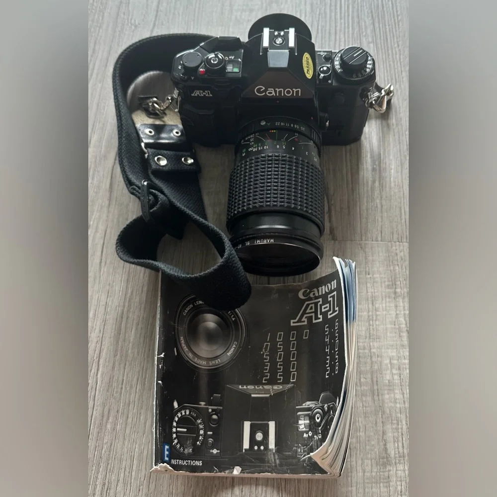 Canon A-1 Black SLR with Pamphlet and Strap
